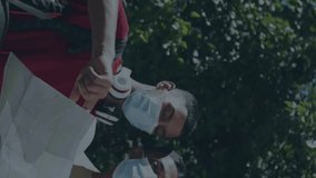 Animation of network of media icons over two male friends in face masks reading map in street. Global communication network and travel during covid 19 pandemic concept digitally generated video. - Powered by Shutterstock - Get 15% off with code: PIKWIZARD15