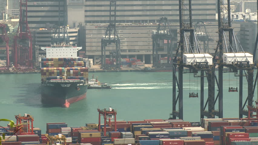 HONG KONG, CHINA - AUGUST 2012: Container Ship Maneuvering In Port. Shot