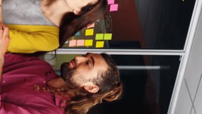 Animation of social media icons over team of diverse colleagues discussing over laptop at office. Social media networking and business technology concept - Powered by Shutterstock - Get 15% off with code: PIKWIZARD15