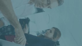 Animation of financial data processing against diverse colleagues discussing over a laptop at office. Global finance and business technology concept - Powered by Shutterstock - Get 15% off with code: PIKWIZARD15