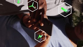 Animation of ecology icons over african american couple fueling car and using smartphone. Global ecology, car and digital interface concept digitally generated video. - Powered by Shutterstock - Get 15% off with code: PIKWIZARD15