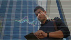 Male professional tapping tablet and monitoring tech waveform over office building glass facade. Futuristic, innovation, technology, urban, digital, connectivity, sleek - Powered by Shutterstock - Get 15% off with code: PIKWIZARD15