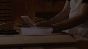 Man tapping tablet in kitchen starting finance charts and soccer bouncing then studying blueprint. Technology, innovation, digital, modern, casual, productivity, data - Powered by Shutterstock - Get 15% off with code: PIKWIZARD15