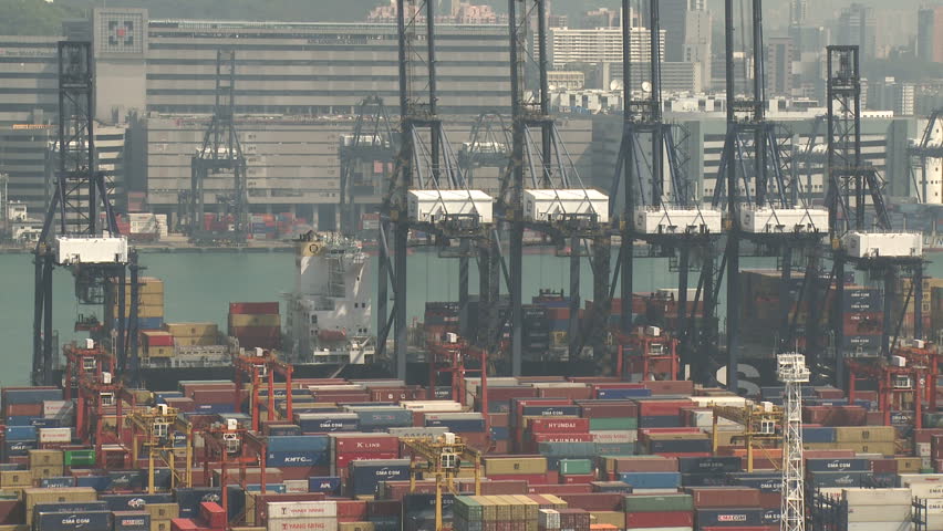 HONG KONG, CHINA - AUGUST 2012: Cranes Moving To Unload Container Ship. Shot