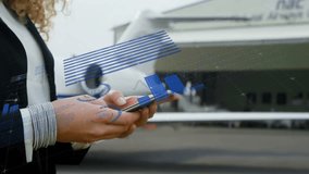 Businesswoman raising hands and tapping smartphone, generating aviation bars pie chart on tarmac. Technology, data visualization, innovation, finance, corporate, professional, futuristic - Powered by Shutterstock - Get 15% off with code: PIKWIZARD15