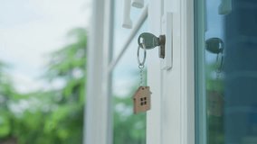 House shaped keychain and keys. Real estate, home, ownership, security, property, realty. house key for unlocking new house is plugged into door. house for sell concept. Rent buy residence. Moving - Powered by Shutterstock - Get 15% off with code: PIKWIZARD15