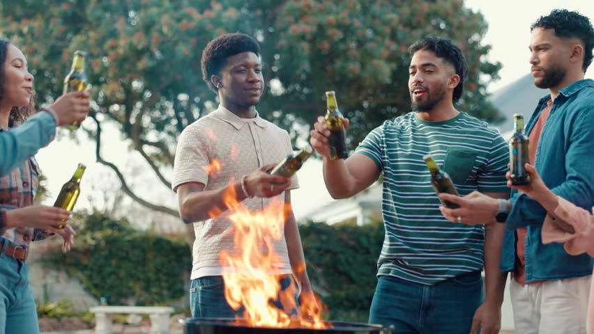 Cheers, beer and people at outdoor barbecue for new years party, celebration or event in backyard. Happy, bonding and group of friends with alcohol beverage for toast together by fire for grill.