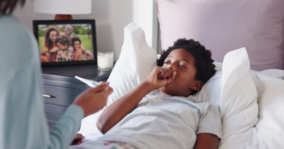 Mom, sick child and fever with thermometer in bed for illness, influenza or allergy in home. Mother, kid and checking temperature with son for monitoring flu, childcare or cold symptoms in bedroom