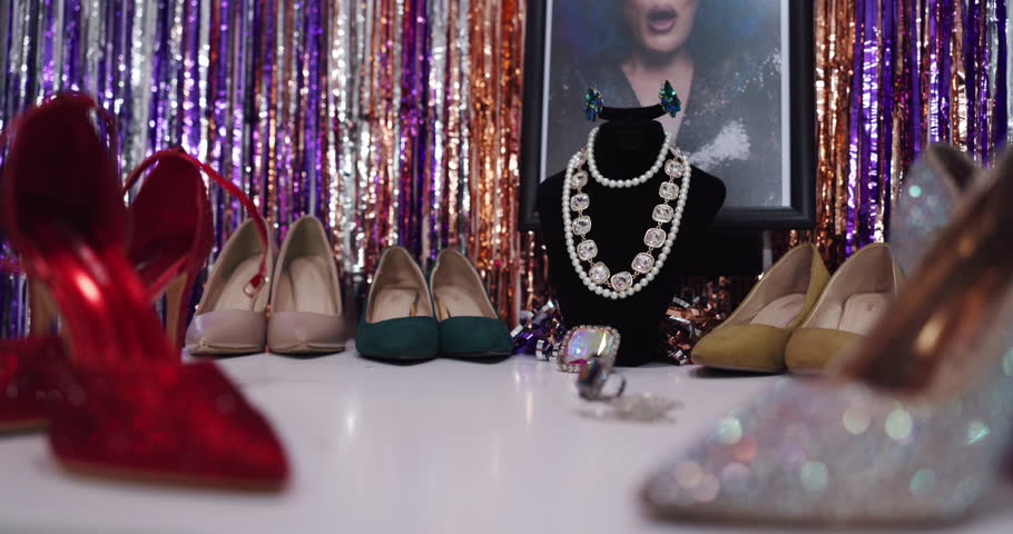Drag, fashion display and shoes on dressing table for theater, jewelry or photo frame of artist. Lgbtq, closet or wardrobe setup with necklace on mannequin, style or high heels showcase with sparkle