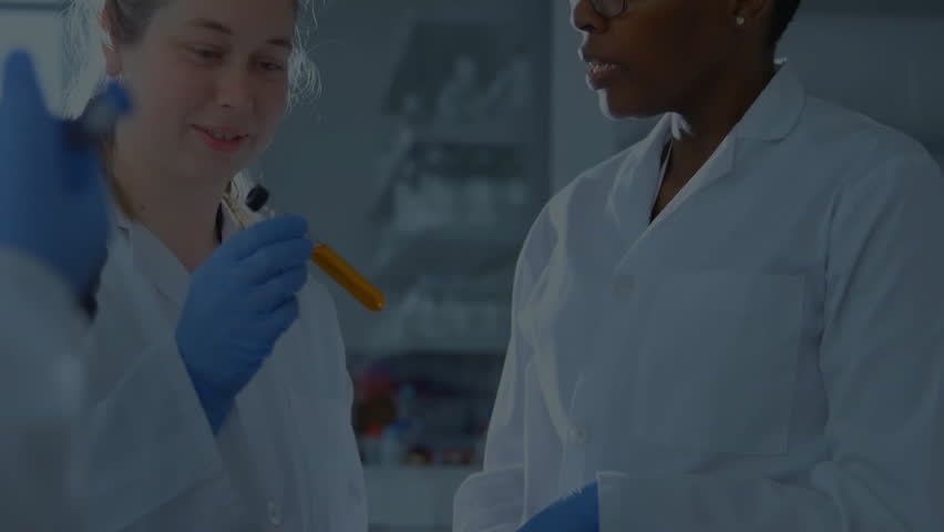 Two scientists examining test tube of orange liquid causing data bars expanding across laboratory. Science, collaboration, research, innovation, technology, analysis, precision - Powered by Shutterstock - Get 15% off with code: PIKWIZARD15