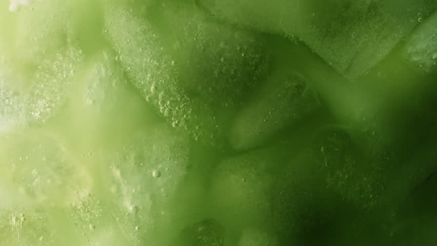 Super Slow Motion Detail Shot of Pouring Cream into Matcha Latte at 1000fps.