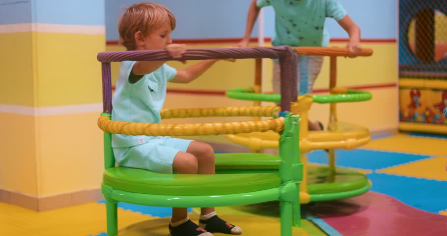 Children Playing on Colorful Playground Equipment Indoors