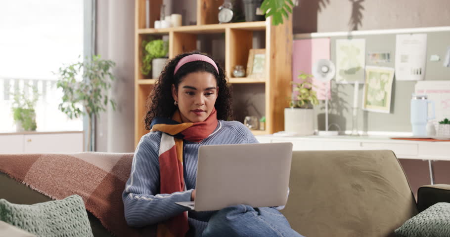 Creative, woman and typing with laptop on sofa for blog editing, fast checking info or remote work. Freelancer, writer and proofreading with tech in home for source verification, article and research