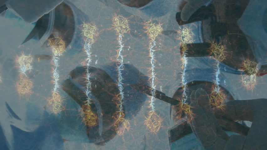 Animation of dna strand over surgeons in face masks. global medicine, technology, data processing and digital interface concept digitally generated video. - Powered by Shutterstock - Get 15% off with code: PIKWIZARD15