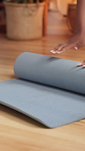 Closeup, hands and rolling yoga mat, home and done with workout, wellness and fitness in apartment. Healthy, person and finished with morning routine, floor and exercise for self care in house
