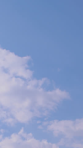 Fast-moving white clouds stretch across a vivid blue sky in a dramatic time-lapse. A breathtaking weather scene, perfect for nature backgrounds, sky transitions, or travel-related content.