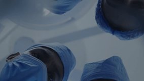 Animation of dna strand spinning over diverse suergeons. Global medicine, connections, computing and data processing concept digitally generated video. - Powered by Shutterstock - Get 15% off with code: PIKWIZARD15