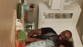 Social media interaction icons animation over couple cooking together in kitchen. digital, communication, sharing, domestic life, bonding, modern technology - Powered by Shutterstock - Get 15% off with code: PIKWIZARD15