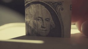 Putting a Dollar Bill into a Money Savings Box - Powered by Shutterstock - Get 15% off with code: PIKWIZARD15