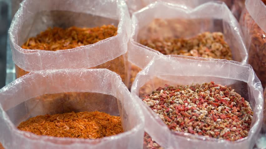 Traditional asian dried food market stall full of dried shrimps in local market Thailand.