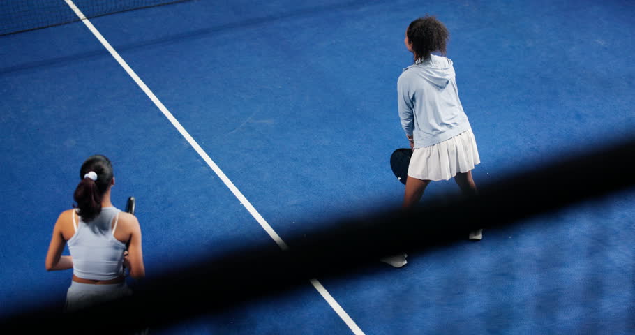 Above, high five and padel with women at venue for competition, point scoring or tournament. Sports, fitness and motivation with friends on tennis court together for success, victory or winning