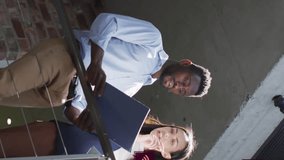 Animation of connected icons forming globe, low angle view of diverse coworkers sharing ideas. Digital composite, multiple exposure, communication, globalization, teamwork and technology concept. - Powered by Shutterstock - Get 15% off with code: PIKWIZARD15