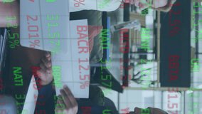 Two business colleagues are working on a laptop and discussing paperwork. Global business and data processing concept digitally generated video. - Powered by Shutterstock - Get 15% off with code: PIKWIZARD15