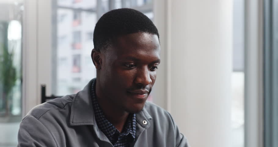 Face, business and smile with black man in office, about us and creative copywriter. Portrait, intern and happy professional employee or African worker with opportunity as content writer in Ghana