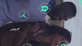 Animation of ecology icons over happy diverse couple on road trip embracing by car. Ecology, economy, travel, transport, vacation, connection and communication, digitally generated video. - Powered by Shutterstock - Get 15% off with code: PIKWIZARD15