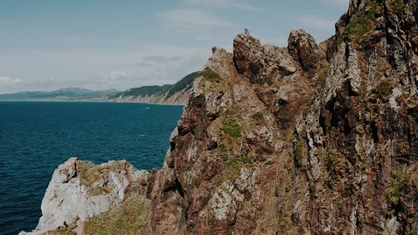 Flight around the mountain with a sea view. coastal cliffs. Sakhalin.