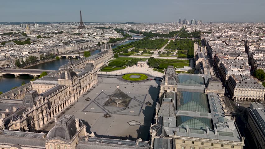 Aerial drone view of the sleepy streets of Paris, France, overlooking at sunrise or sunset. Low motion over the rooftops. Cinematic 4k. Europe from above.