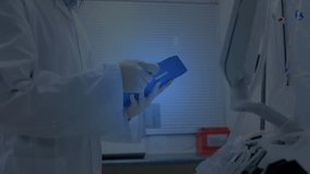 Female lab researcher flipping binder accessing workstation with intensifying DNA helix data review. Scientist, laboratory, research, innovation, technology, genetics, analysis - Powered by Shutterstock - Get 15% off with code: PIKWIZARD15