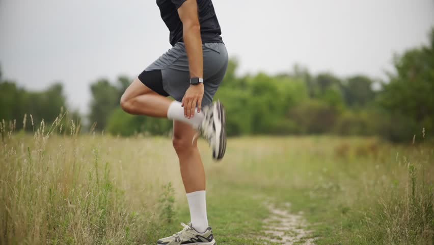 Athlete Warming Up Before Exercise Running. Male Runner Stretching Quadriceps.Sport Recreation Running. Fitness Training Pre-Workout Routine. Flexibility And Mobility Sport Running. Runner Exercise Preparation Dynamic Stretching. Cardio Preparation Run. Endurance Exercising Sport. Runner Fitness Activity. Jogger Muscular Exercising . Difficult Sport Skills. Professional Runner Fitness Exercising. Running In City