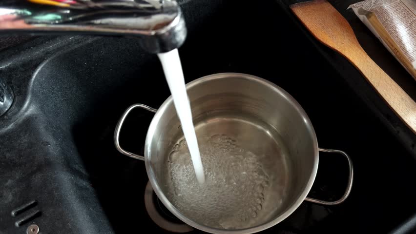 Kitchen Faucet Filling A Metal Pot With Water For Pasta. Cooking Preparation. Food Preparation Process. Kitchen Utensils Meal Prep. Kitchen Sink And Clean Water. Stainless Steel Pot. Liquid Flow