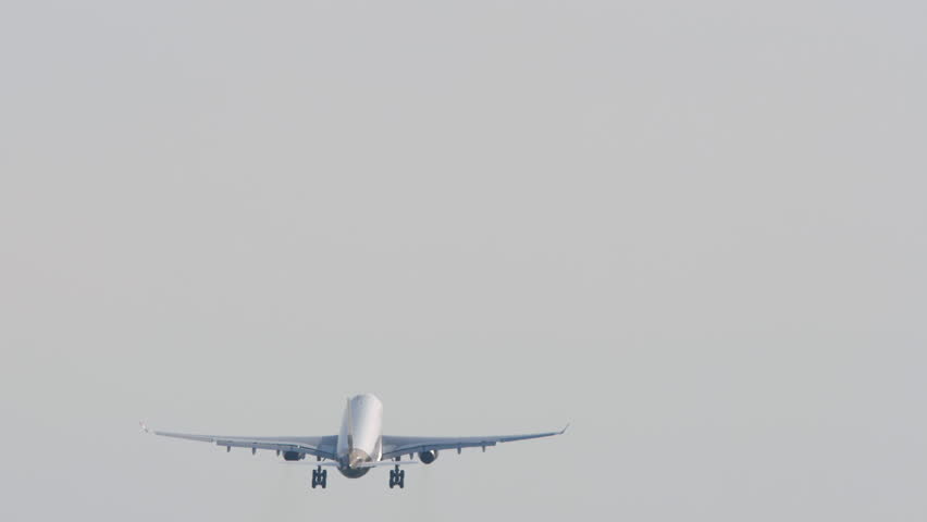 Footage of jet passenger plane taking off. Airliner climbing, rear view. Commercial aircraft in the sky