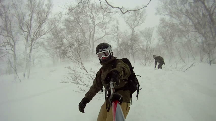 Extreme Snowboarder Blasts Through Backcountry Powder Snow. Snow flies