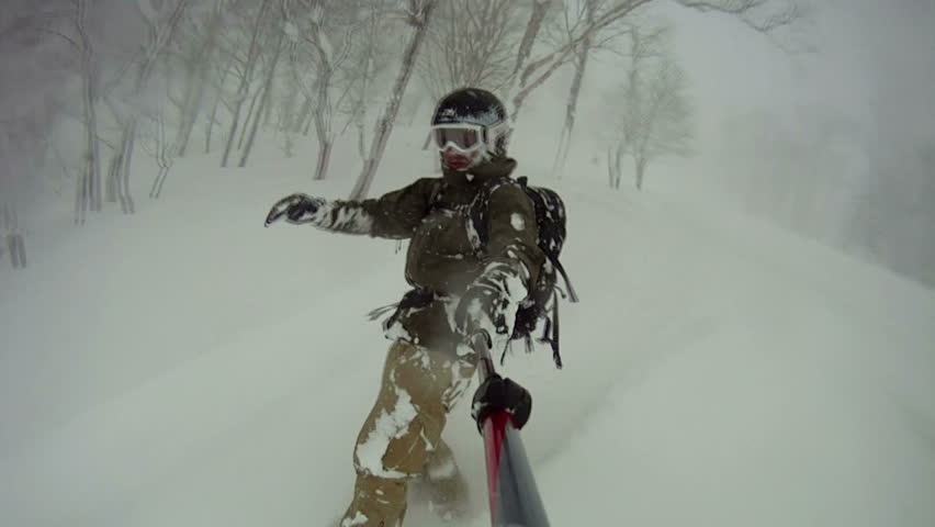 Extreme Snowboarder Blasts Through Backcountry Powder Snow. Snow flies