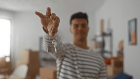 Young man with keys standing in new home, smiling in modern apartment. - Powered by Shutterstock - Get 15% off with code: PIKWIZARD15