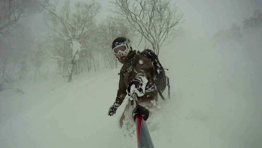 Extreme Snowboarder Blasts Through Powder Snow Slow Motion. Snow flies
