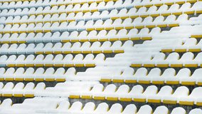 Empty stadium seats blanketed in fresh snow during winter. Cold and quiet atmosphere in sports arena off-season, stillness before the crowd. - Powered by Shutterstock - Get 15% off with code: PIKWIZARD15