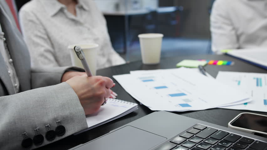 Colleagues discussing marketing data charts and KPIs in office meeting, teamwork and strategy development - Powered by Shutterstock - Get 15% off with code: PIKWIZARD15