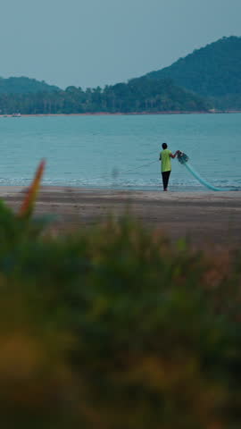 Fisherman casting net on the beach of ao thung makham