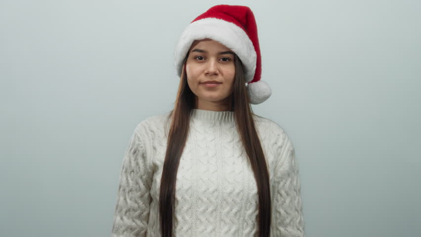Woman in santa hat and sweater pledging allegiance over white background