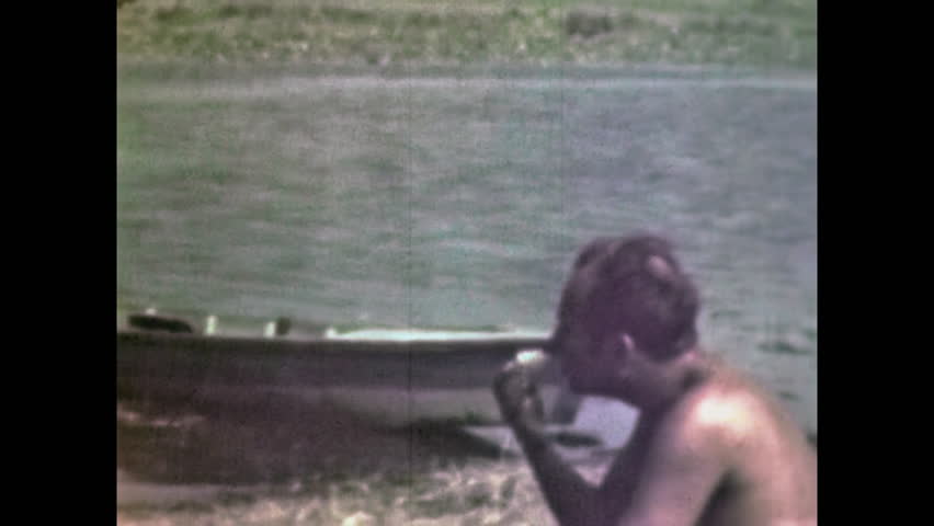 Rural man slowly enjoying rural tranquility in summer river nature. Countryside mood, nature connection. Traditional masculine male person relax. Vintage film. Old archive. Archival retro 1960s