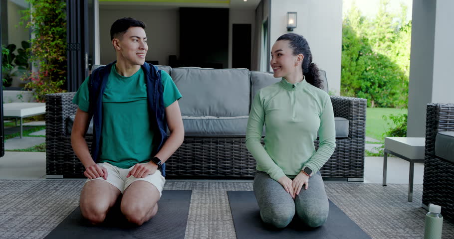 Arm tapping starting couple kneeling on patio mats stretching child pose, lunging hip stretch. Fitness, wellness, companionship, outdoor, relaxation, harmony, activity