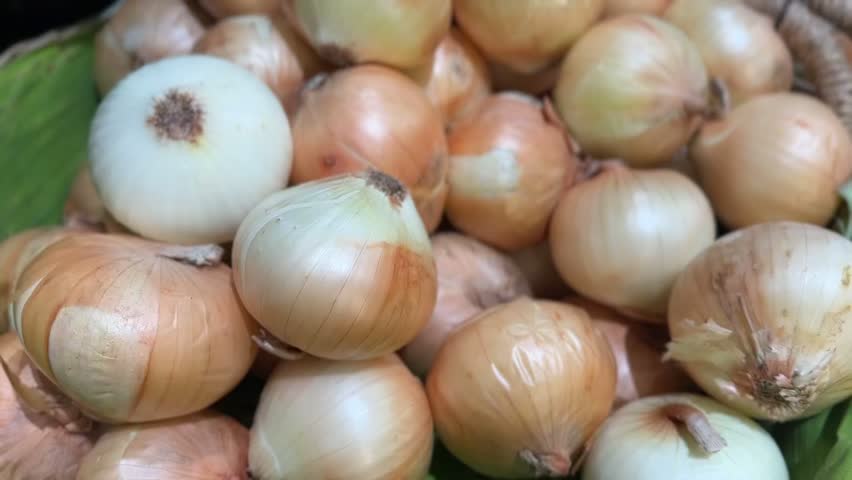 Fresh onions close-up in basket highlighting layered skins and rustic organic freshness