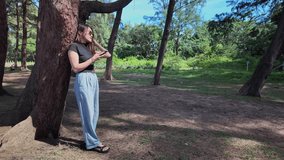 Slow motion video of young woman walking along the beach holding a phone under the shade of a pine tree by the sea.A large tunnel of pine trees along the beach catches the eye
beautiful natural place - Powered by Shutterstock - Get 15% off with code: PIKWIZARD15