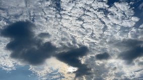 Clouds in the sky. Time - lapse capturing dynamic cloud formations swirling, with sunlight piercing through gaps, highlighting dramatic cloud transformations. - Powered by Shutterstock - Get 15% off with code: PIKWIZARD15