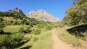 Peaceful mountain trail leading toward the base of Peña Telera, on the route from Piedrafita de Jaca to Ibón de Piedrafita, showing alpine meadows and forest edges in the Pyrenees

 - Powered by Shutterstock - Get 15% off with code: PIKWIZARD15