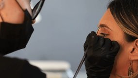 Professional brow tinting and lamination procedure. Close-up of cosmetologist applying dye and shaping eyebrows for a woman in beauty salon, self-care and beauty treatment. - Powered by Shutterstock - Get 15% off with code: PIKWIZARD15
